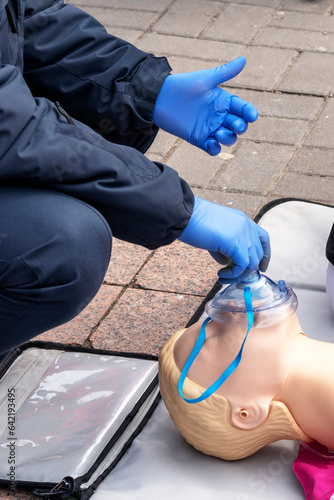 Hands of a Policeman on a mannequin during an exercise of resuscitation. CPR First Aid Training Concept.Urgent Care.