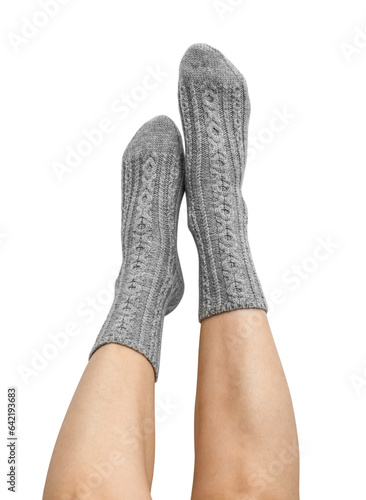 Female legs in grey hand knitted wool socks photo