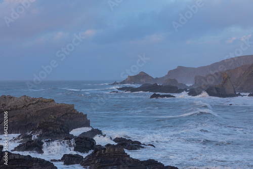 Dramatic seascape with rough seas rolling into the shore