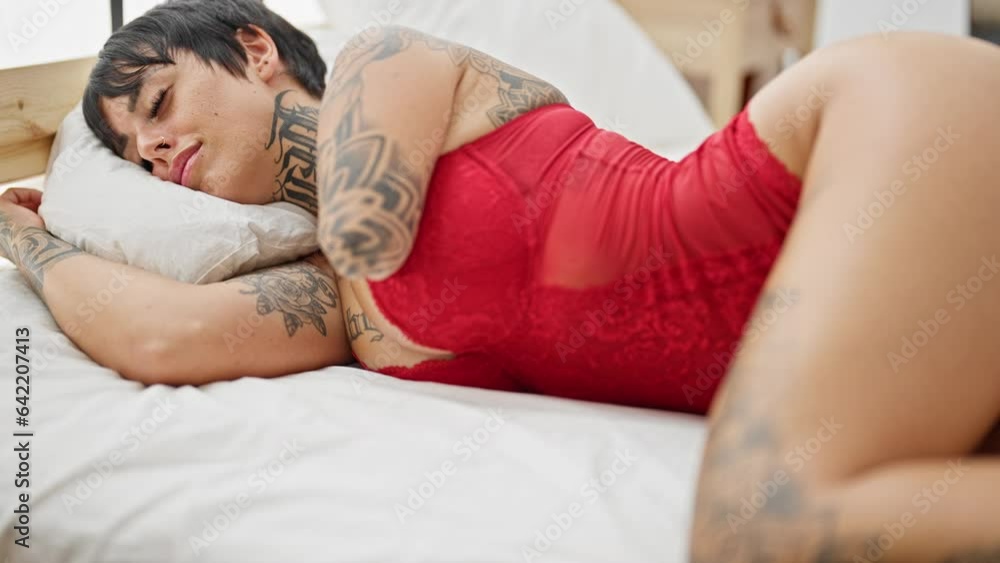 Hispanic woman with amputee arm wearing lingerie lying on bed sleeping at bedroom Hispanic woman with amputee arm wearing lingerie lying on bed sleeping at bedroom