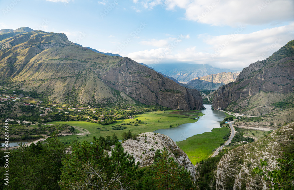 Beautiful landscape with mountains, valley and a river on a sunny summer day with clouds. Dagestan
