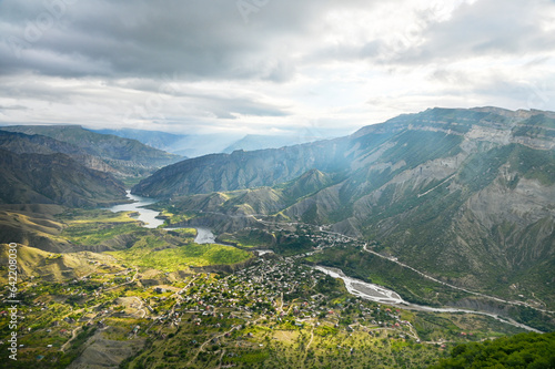 Beautiful landscape with mountains, valley and a river on a sunny summer day with clouds. Dagestan