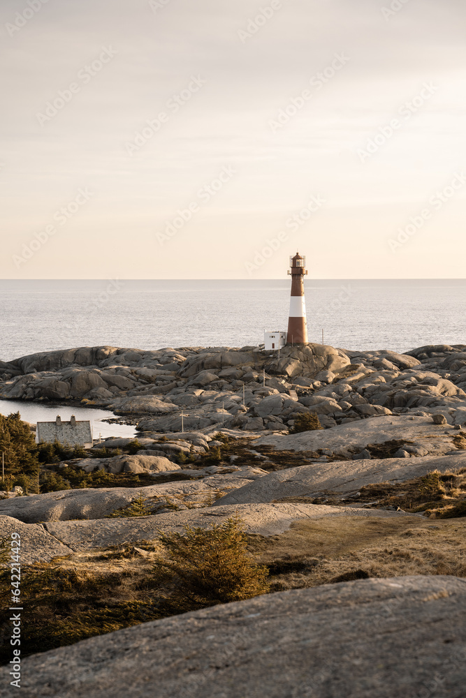 Norway lighthouse at sunset with amazing flat rocks, Negersund Norway