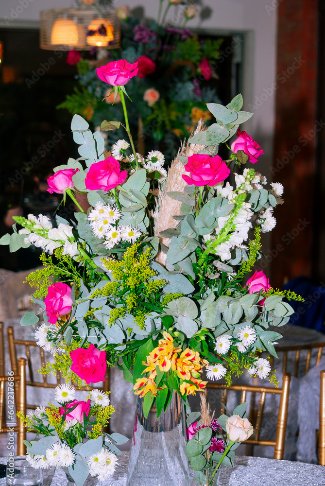 Multicolored floral arrangement made with organic flowers in outdoor space, wedding celebration and family celebration, show of love and hope.