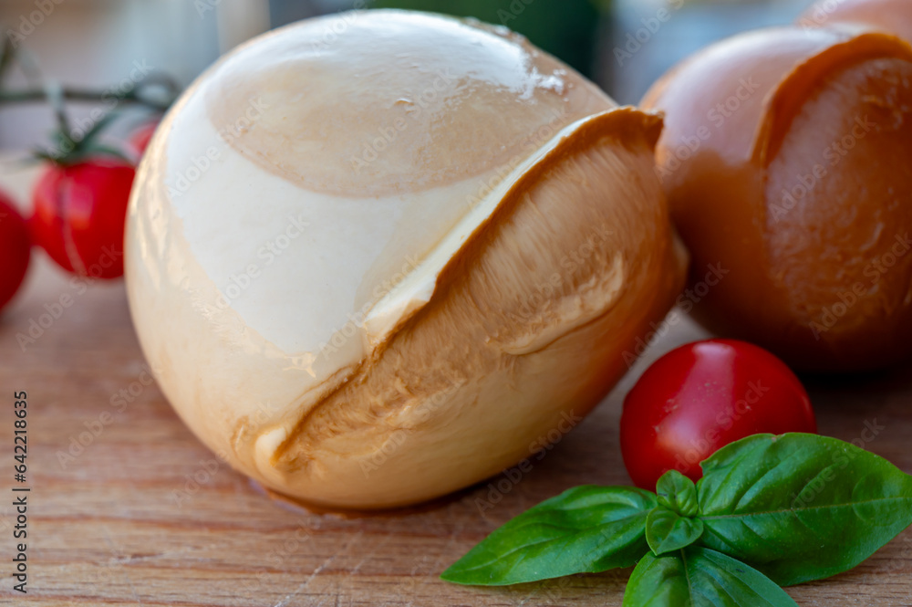 Italian semi hard handmade smoked scamorza cheese, from cow milk from Apulia or Calabria regions close up