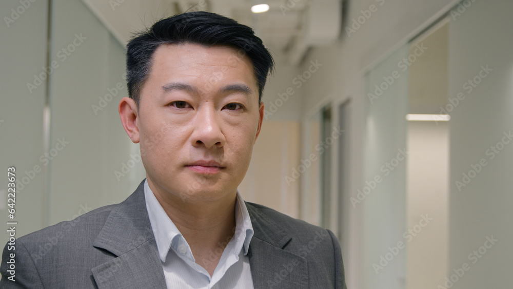 Portrait Asian businessman serious middle-aged ethnic man entrepreneur in office company male mature corporate agent employer looking at camera executive manager business ceo worker lawyer in hallway Portrait Asian businessman serious middle-aged ethnic man entrepreneur in office company male mature corporate agent employer looking at camera executive manager business ceo worker lawyer in hallway
