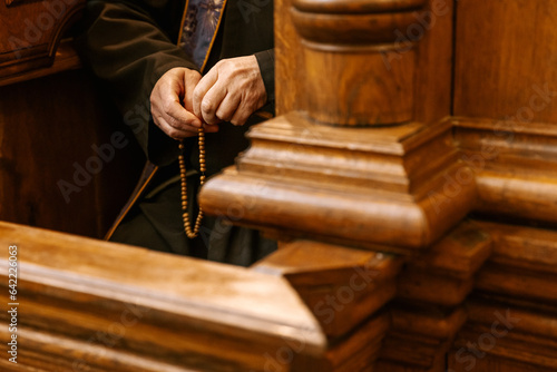 the secret of confession in the Catholic church: Photo of the hands of the priest confessing in the confessional photo