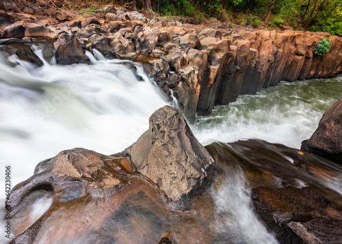 Waterfall cascades,over jagged rocks and boulders at Maak Ngaew falls,near Pakse,Southern Laos. photo