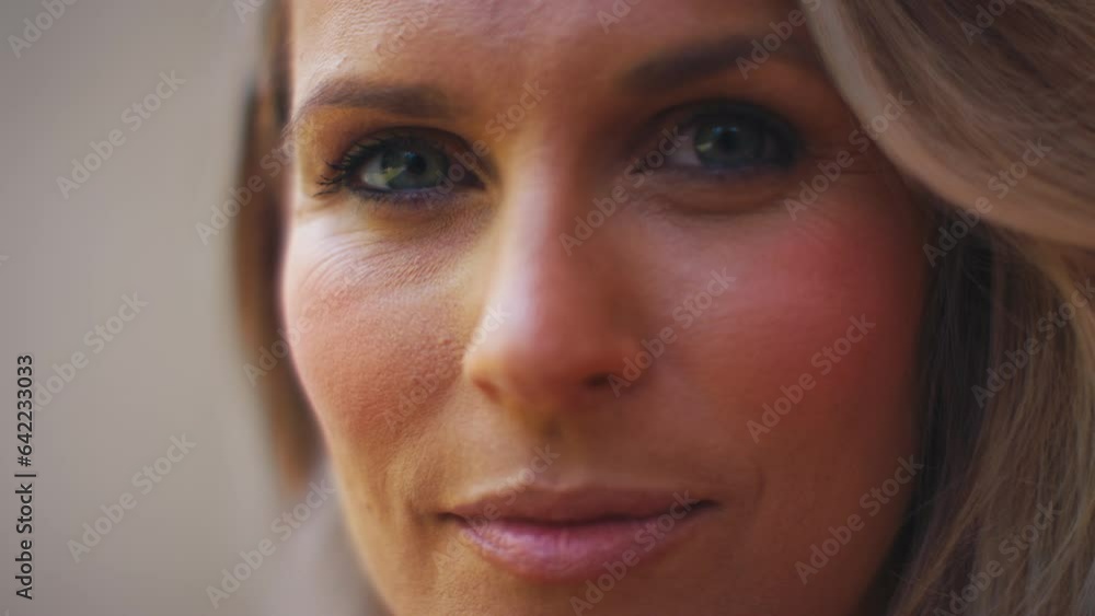 Close up beauty portrait of smiling mature woman against natural background - shot in slow motion Close up beauty portrait of smiling mature woman against natural background - shot in slow motion
