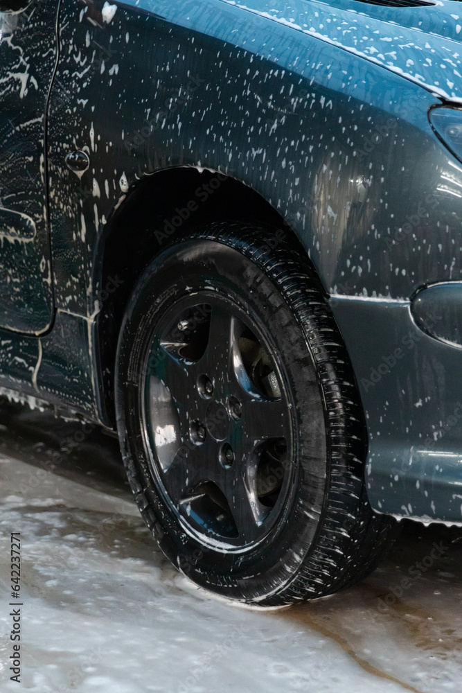 Detail view of a car wheel filled with foam.