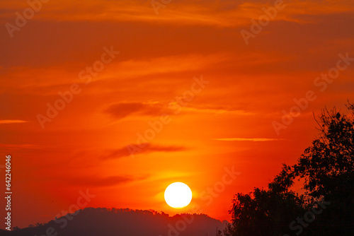 Amazing sky at sunset. Gradient color. Sky texture  abstract nature background..Sunset with red color light rays and other atmospheric effects..Big sunset and sweet lighting sky. phone antenna post.