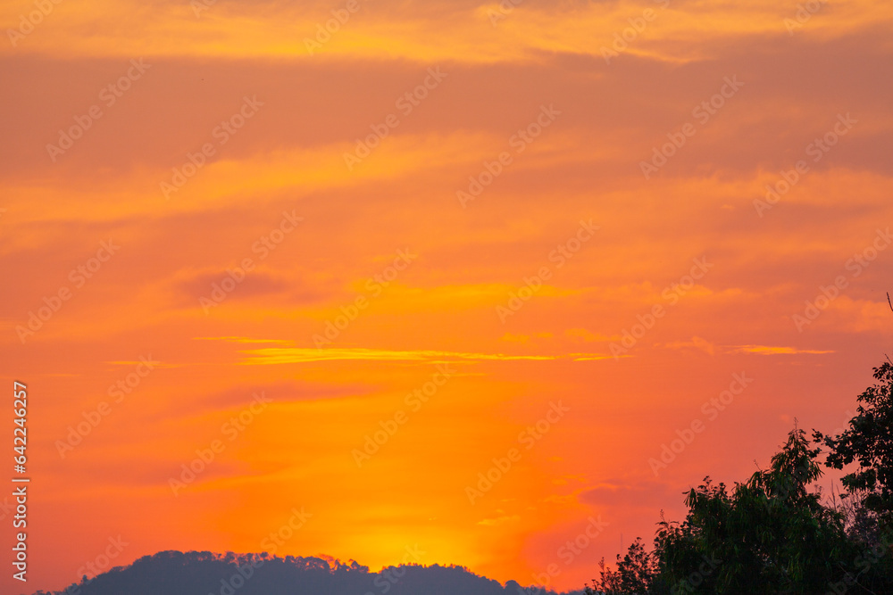 Amazing sky at sunset. Gradient color. Sky texture, abstract nature background..Sunset with red color light rays and other atmospheric effects..Big sunset and sweet lighting sky. phone antenna post.