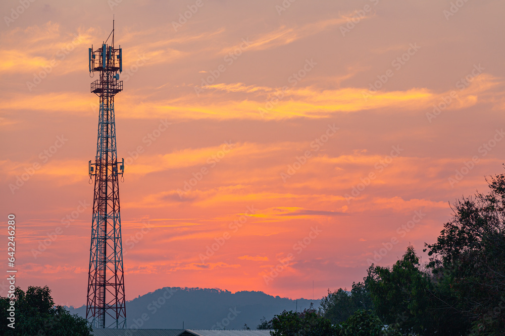 Amazing sky at sunset. Gradient color. Sky texture, abstract nature background..Sunset with red color light rays and other atmospheric effects..Big sunset and sweet lighting sky. phone antenna post.
