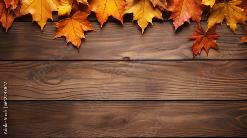 Wooden background with colorful autumn leaves. Autumn background with copy space.