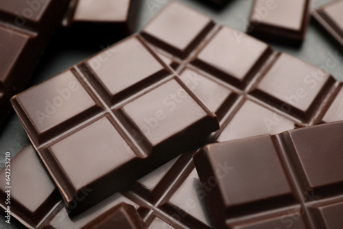 Delicious dark chocolate on black table, closeup