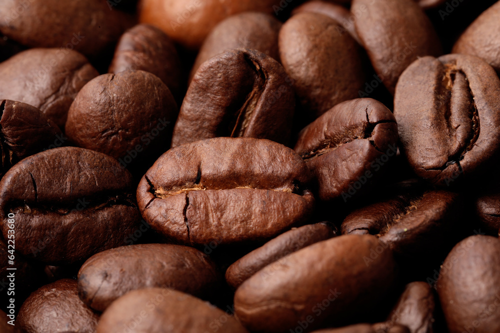 Naklejka premium Aromatic roasted coffee beans as background, closeup