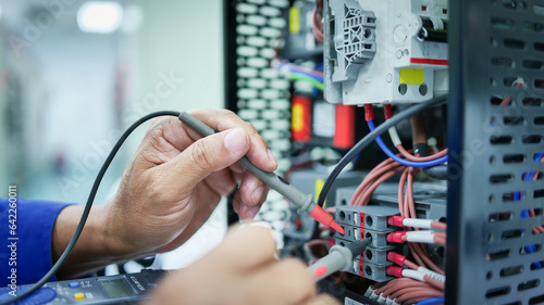 Discover essence of industrial technology as engineer ensures safe operation, fixing automatic control switchboard. Optimize visibility for microstock platforms. Passionate photographer's unique 