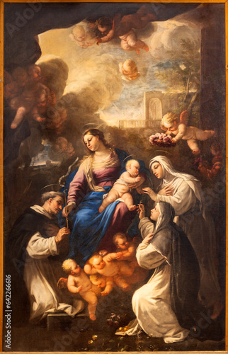 NAPLES, ITALY - APRIL 20, 2023: The painting of Madonna presenting the Rosary to st. Dominic in the church Basilica di Santa Maria della Sanita by Giovanni Balducci (1560 – 1631). photo