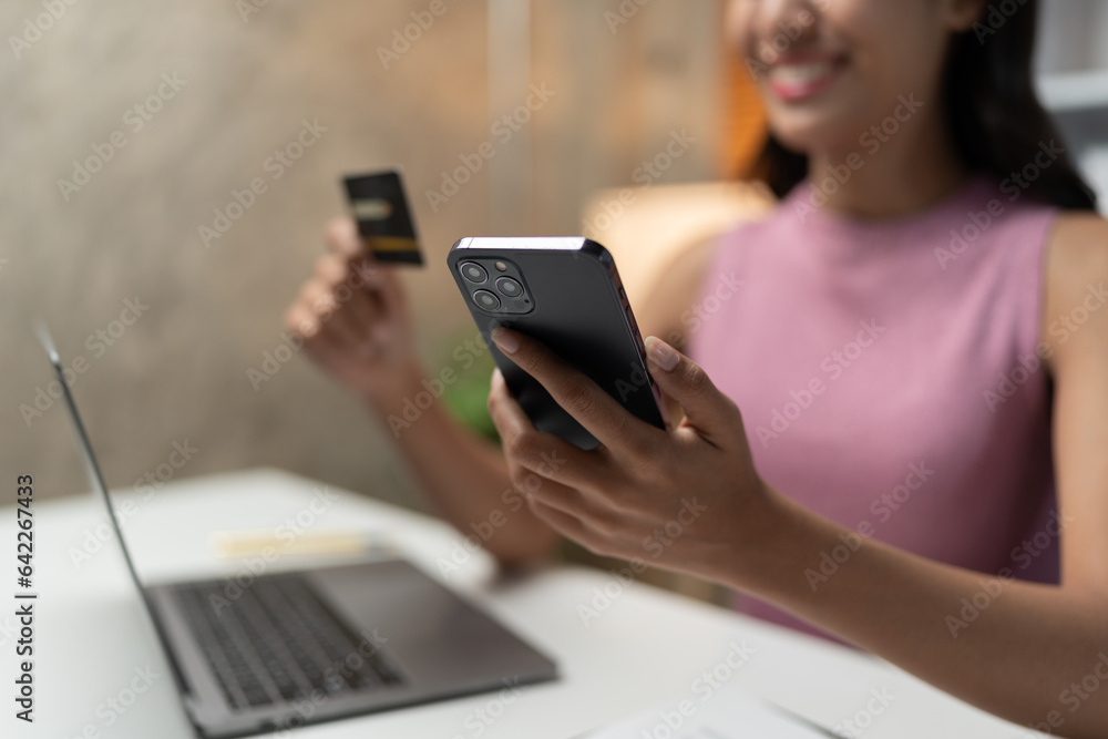 Confident Asian businesswomen sitting at their desks Are using banking applications to buy or pay online mobile bills. and registered her credit card on the website for online purchases. Confident Asian businesswomen sitting at their desks Are using banking applications to buy or pay online mobile bills. and registered her credit card on the website for online purchases.