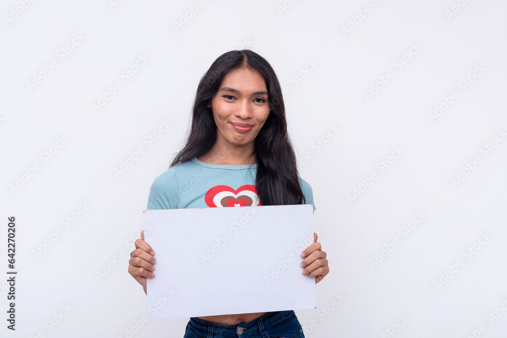 A friendly young Asian trans woman smiling pleasantly while holding a white blank signage. Isolated on a white background. A friendly young Asian trans woman smiling pleasantly while holding a white blank signage. Isolated on a white background.
