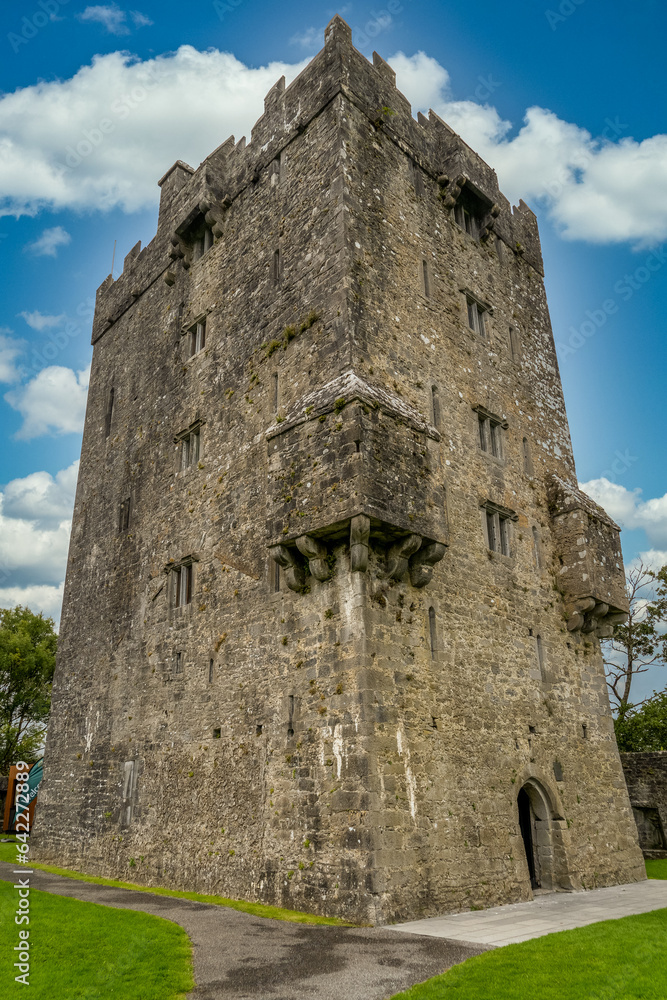 Aughnanure castle in Ireland with large multi-storeytower house keep, cloudy blue sky