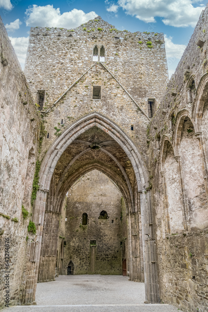 Ruined Gothic abbey on the Rock of Cashel with majestic Gothic arches and windows