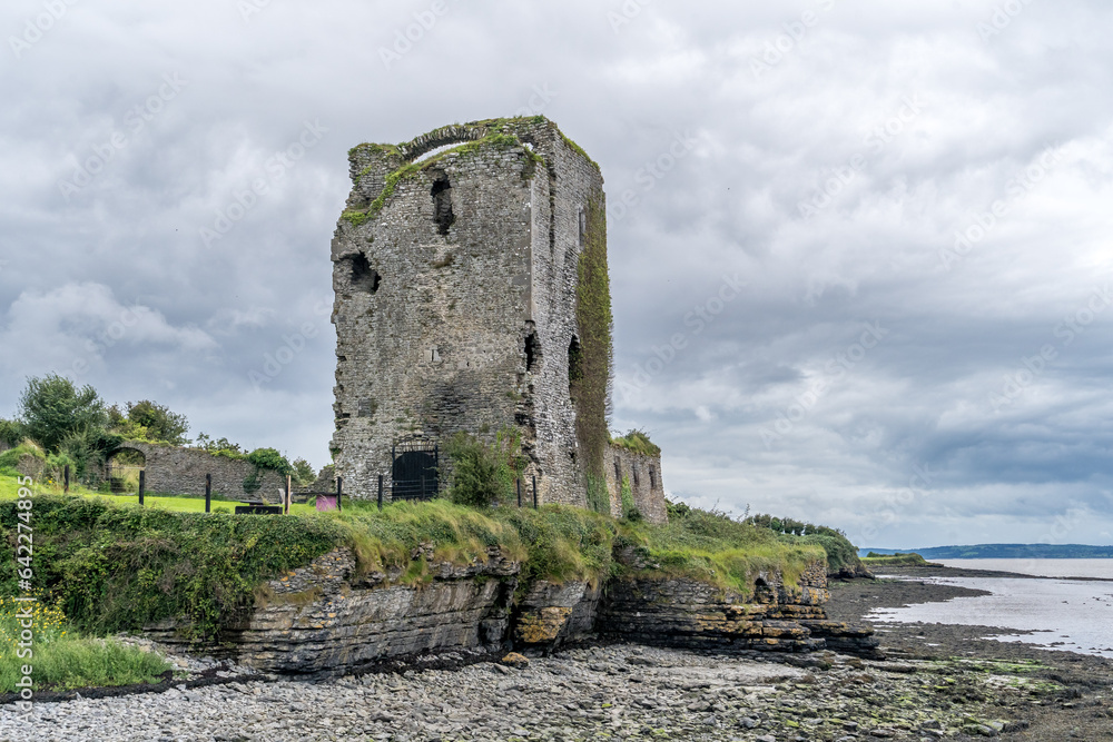 Beagh castle abandoned military tower on the Irish coast with cloudy sky 