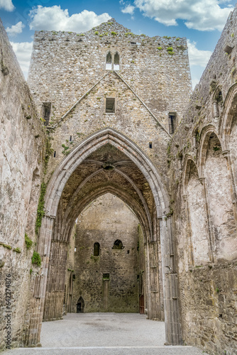 Ruined Gothic abbey on the Rock of Cashel with majestic Gothic arches and windows