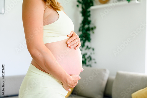 Crop unrecognizable pregnant woman holding belly with hands Free Download Crop unrecognizable pregnant woman holding belly with hands - GFXLoad