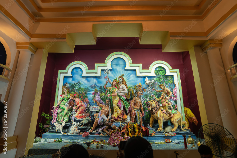Beautifullly decorated Durga Puja idol inside puja pandal. Durga Puja is biggest festival of Hinduism, celebrated all over the world. - obrazy, fototapety, plakaty 