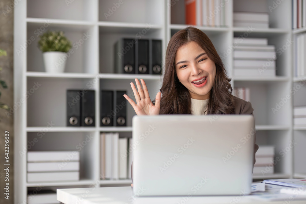 Cheerful business lady working on laptop in office, Asian happy beautiful businesswoman in formal suit work in workplace. Attractive female employee office worker smile. Cheerful business lady working on laptop in office, Asian happy beautiful businesswoman in formal suit work in workplace. Attractive female employee office worker smile.