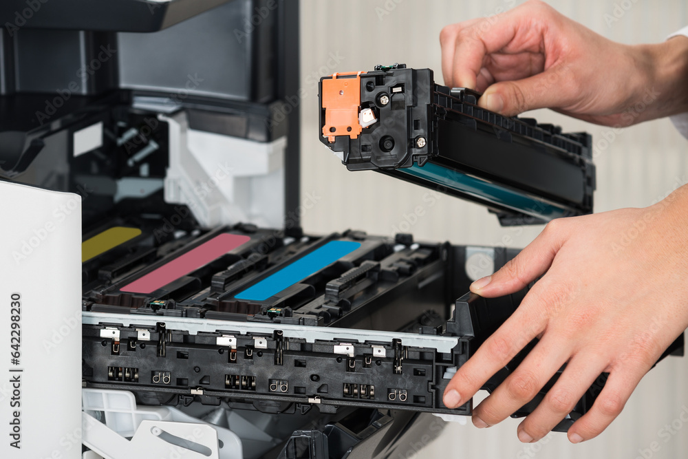 Businessman Fixing Cartridge In Printer Machine At Office Businessman Fixing Cartridge In Printer Machine At Office