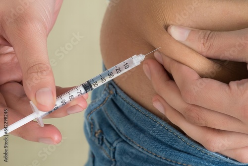 Midsection Of Diabetic Woman Injecting Stomach