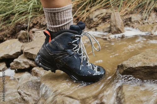 close-up of mountain boots on a water-covered trail