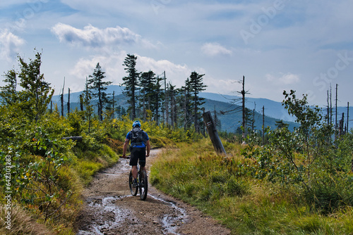 Fototapeta Naklejka Na Ścianę i Meble -  cyclist is riding a bicycle on a mountain peak