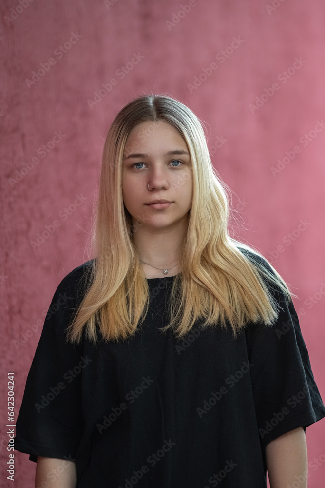 Portrait of a beautiful blonde girl in a black T-shirt. Portrait of a beautiful blonde girl in a black T-shirt.