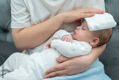 Wet towel comforts a feverish infant, Concept of mother's instinctive care response