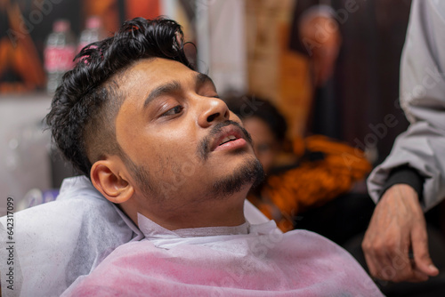 Handsome Barber Carefully Shaving Customer In Barber Shop