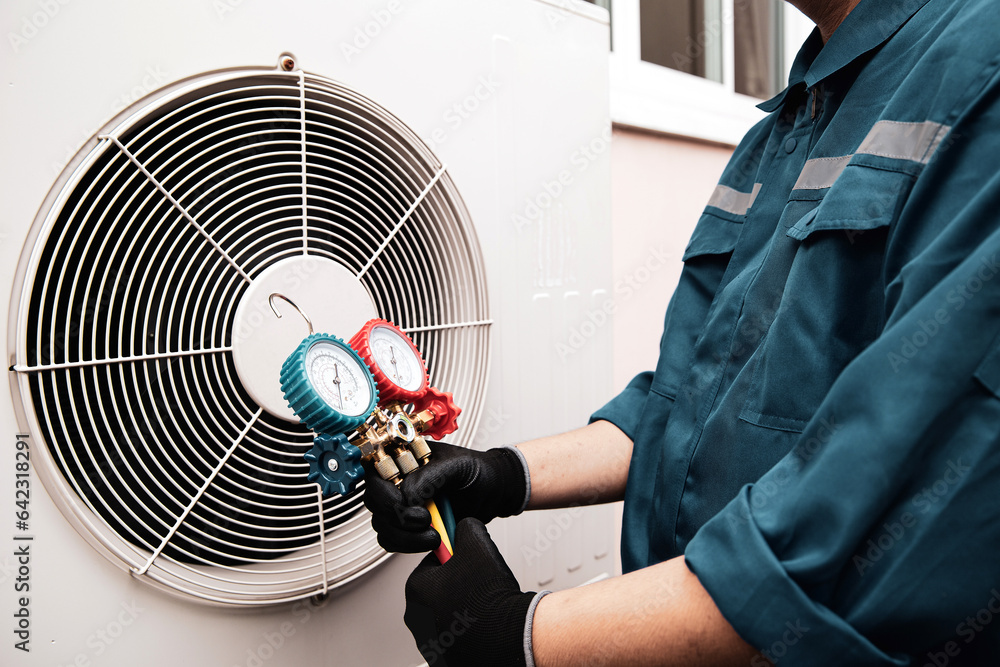 Heat and Air Conditioning, HVAC system service technician using