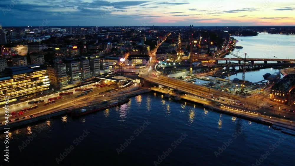Aerial view over the construction site near the old town of Stockholm, with views of the commuter terminal, subway line and road network, evening light. Aerial view over the construction site near the old town of Stockholm, with views of the commuter terminal, subway line and road network, evening light.