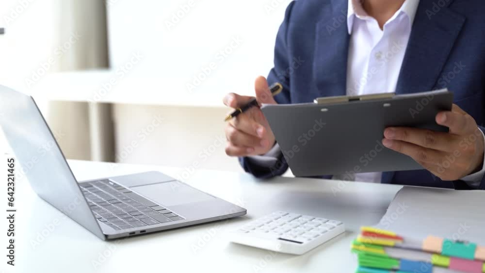 Business man working at office with laptop and documents on desk, financial adviser analyzing data. Business man working at office with laptop and documents on desk, financial adviser analyzing data.