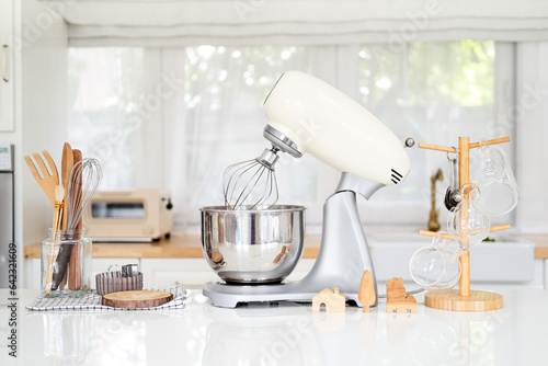 Kitchen background mockup with teepot and cooking, wooden baking utensils ,dough mixer , bowls on the table on white background. Blank space for a text, home kitchen decor concept. photo