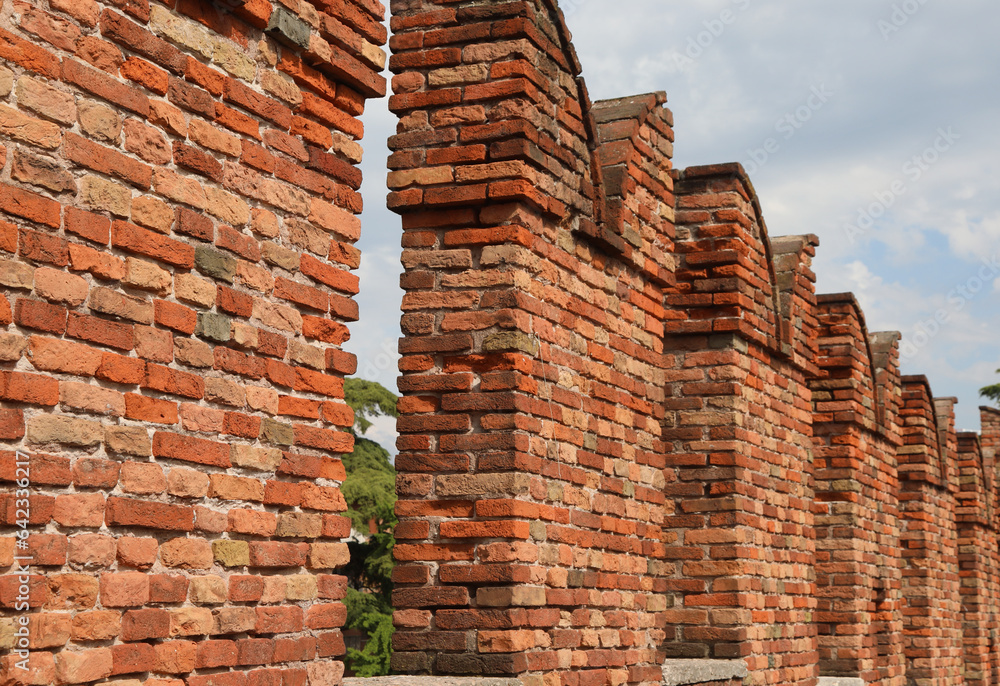 Ancient Battlements with crenellations on the wall made with old bricks Ancient Battlements with crenellations on the wall made with old bricks
