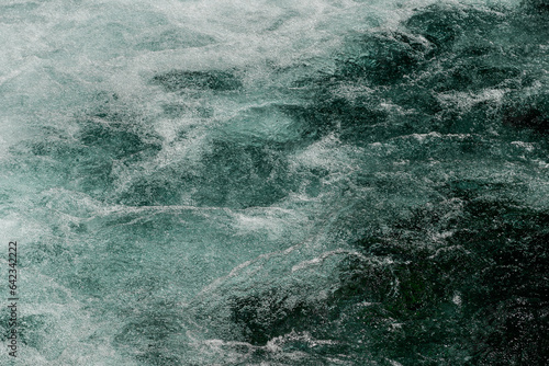 The surface of a turbulent river in its falling course