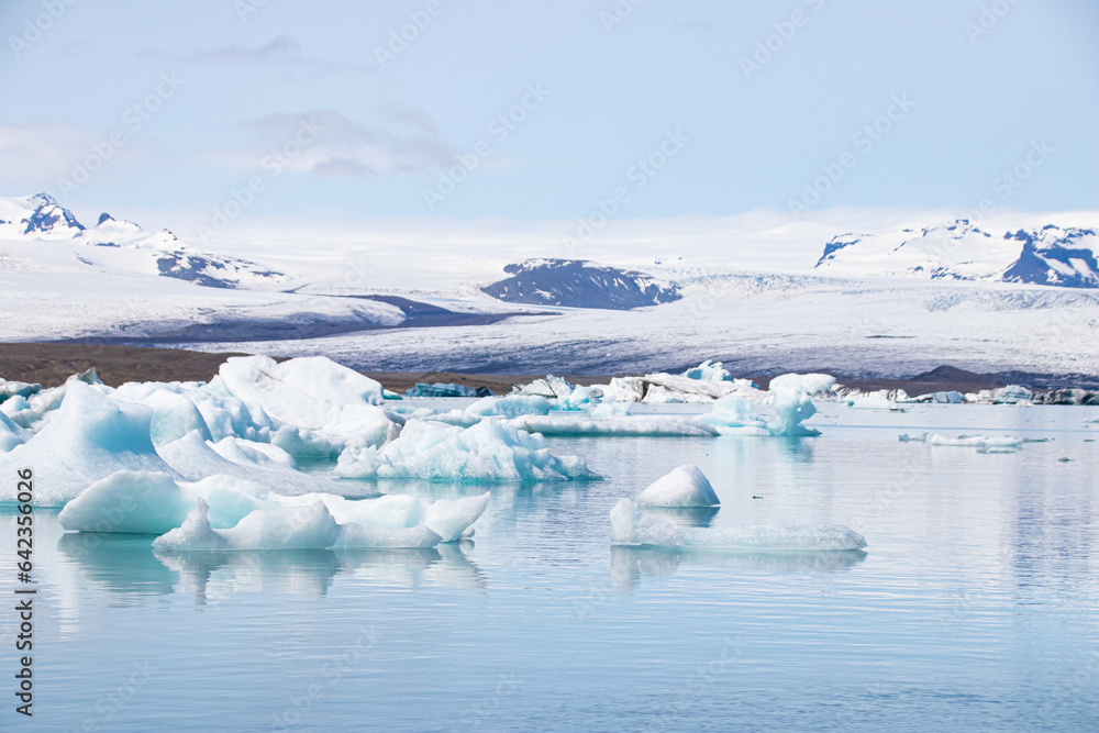 Ice floes in a glacial lake in Iceland with vulcano mountains in the background, the climate crisis in northern Europe, glacial melting, beautiful landsacpe