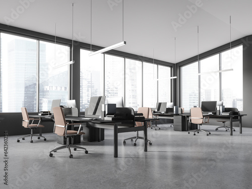Grey workplace interior with pc monitors and table near panoramic window