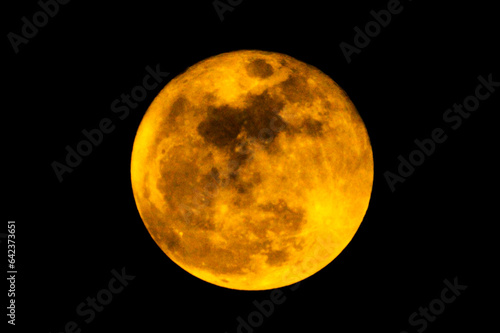 The yellow full moon (super moon) on black background for night and dark design concept. High Quality of full moon photo. 