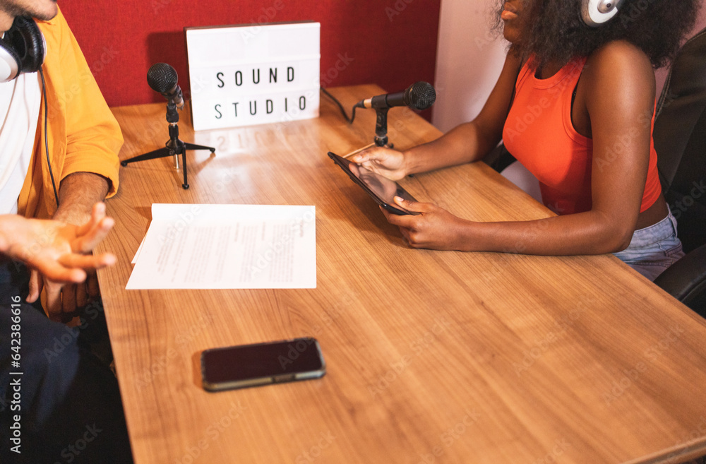 © ADDICTIVE STOCK - Crop young woman sitting with unrecognizable male at table with tablet while recording podcast remotely © ADDICTIVE STOCK - Crop young woman sitting with unrecognizable male at table with tablet while recording podcast remotely