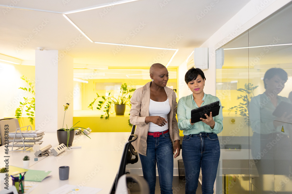 Multiethnic women with tablet in modern office Multiethnic women with tablet in modern office