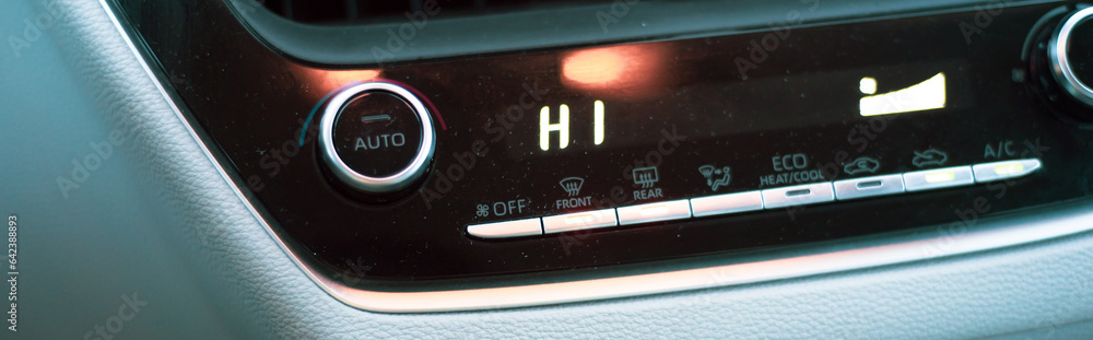 Panorama view highest temperate heat setting with knobs, digital display inside modern leather car interior, defrost mode fan at full blast defogger windshield windows Panorama view highest temperate heat setting with knobs, digital display inside modern leather car interior, defrost mode fan at full blast defogger windshield windows